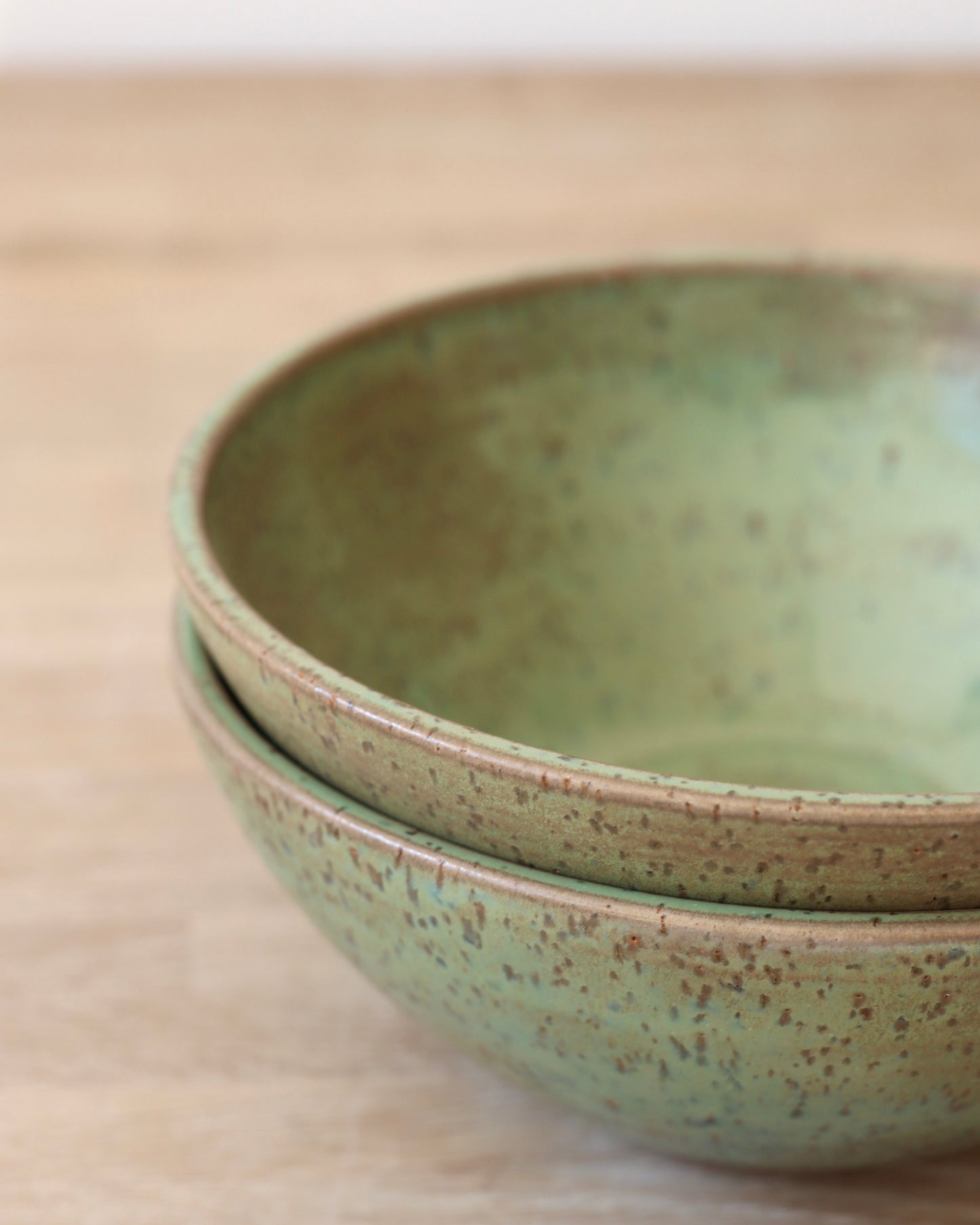 handmade ceramic speckled stoneware bowl set in green tea glaze