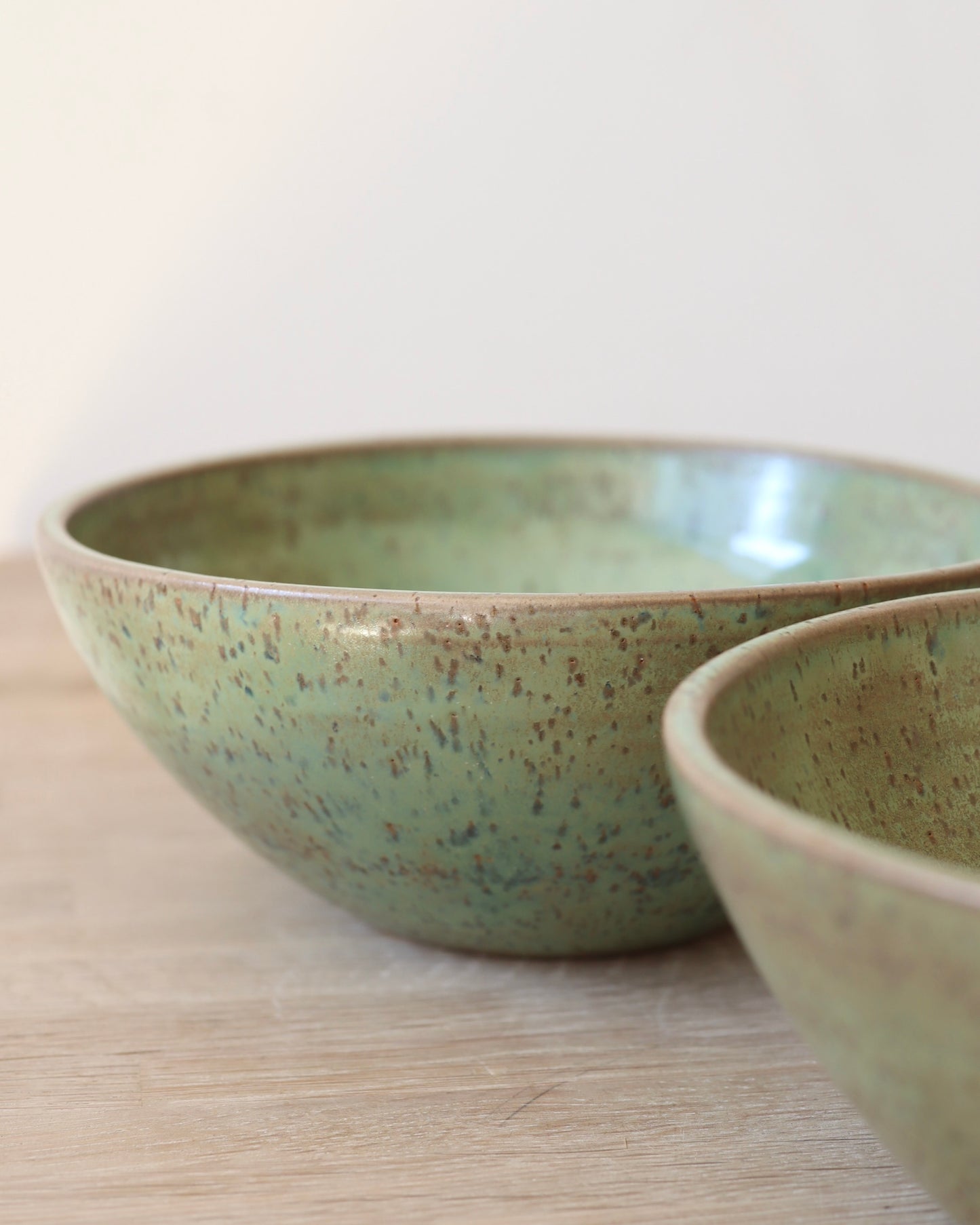 handmade ceramic speckled stoneware bowl set in green tea glaze