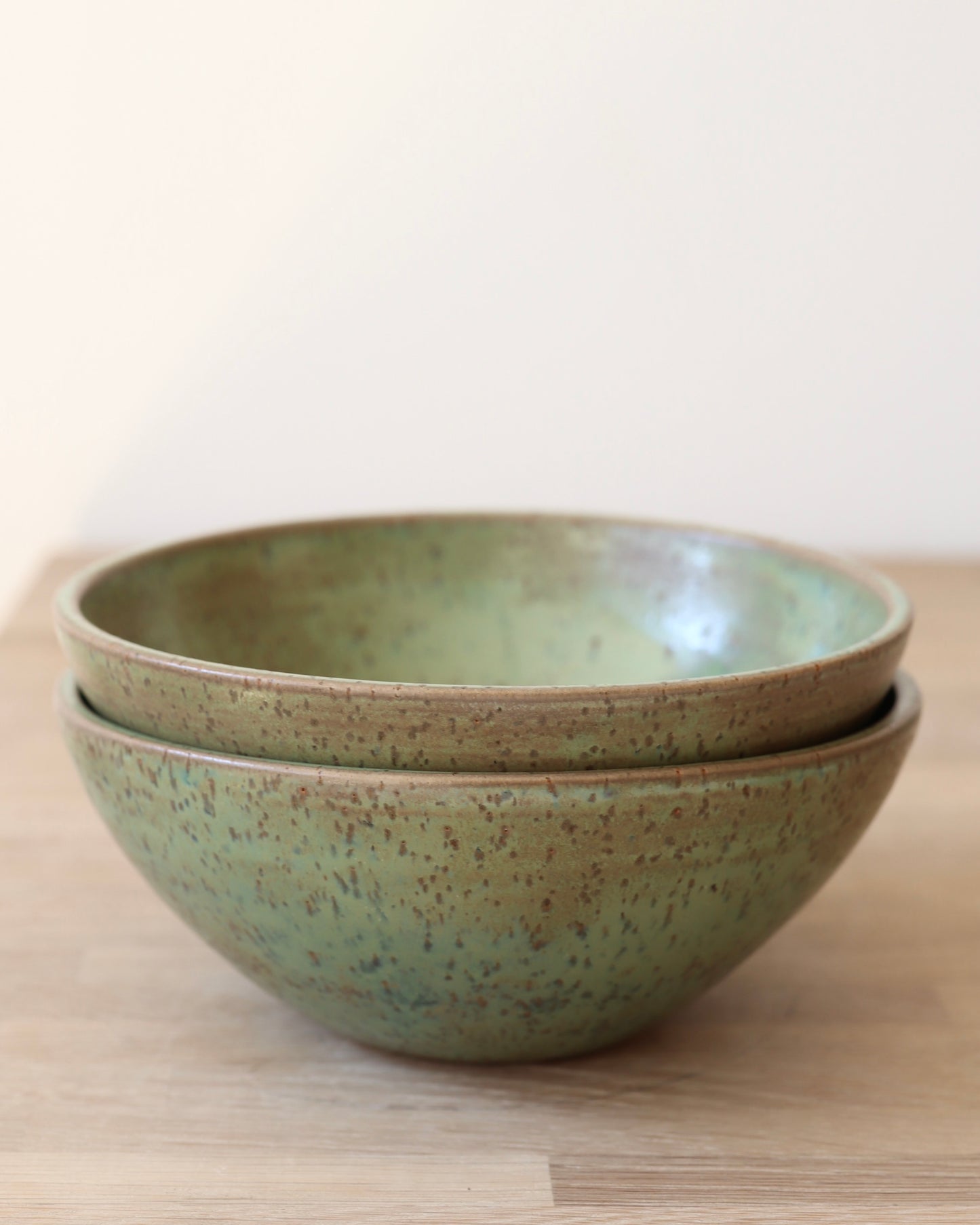 handmade ceramic speckled stoneware bowl set in green tea glaze