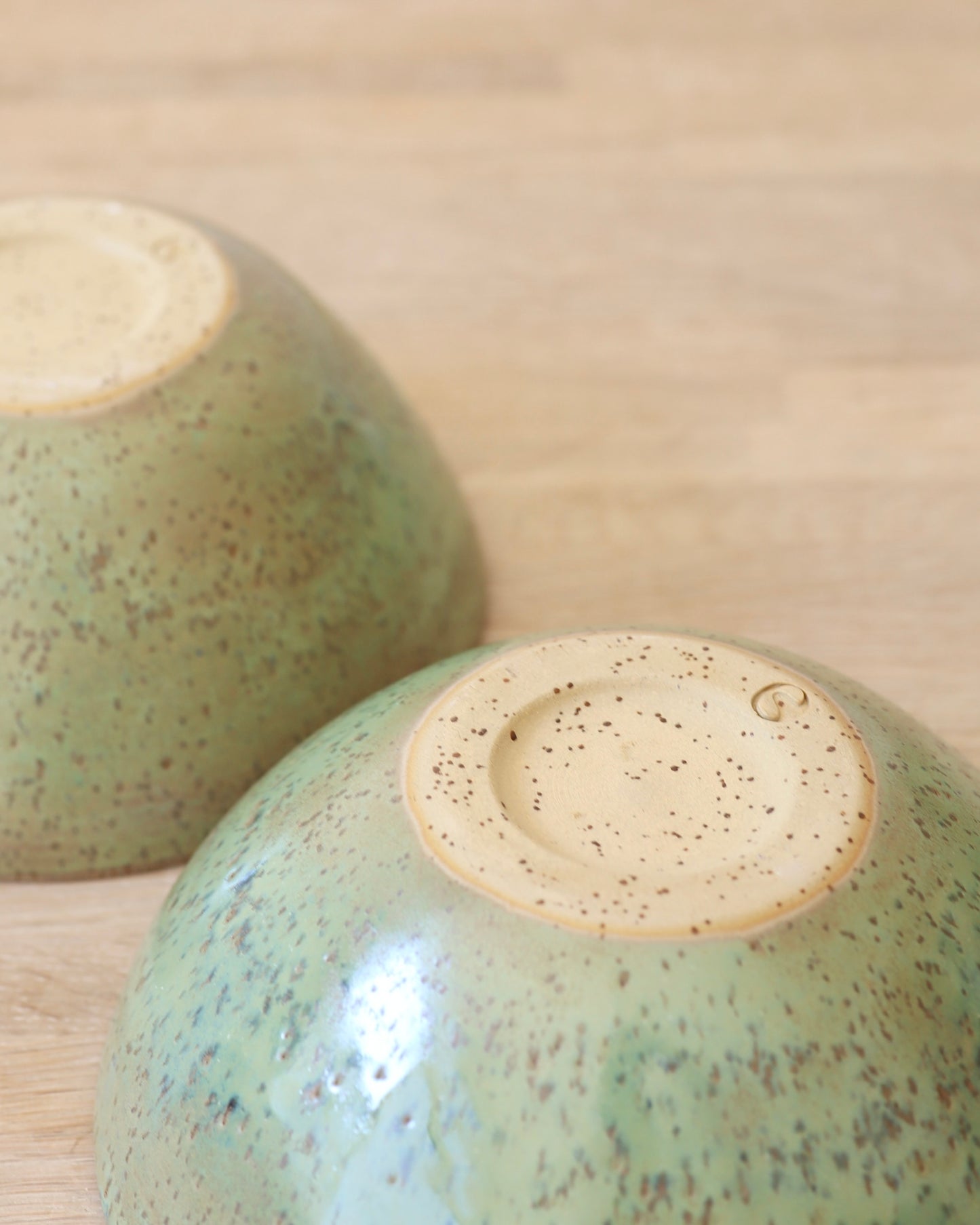 handmade ceramic speckled stoneware bowl set in green tea glaze