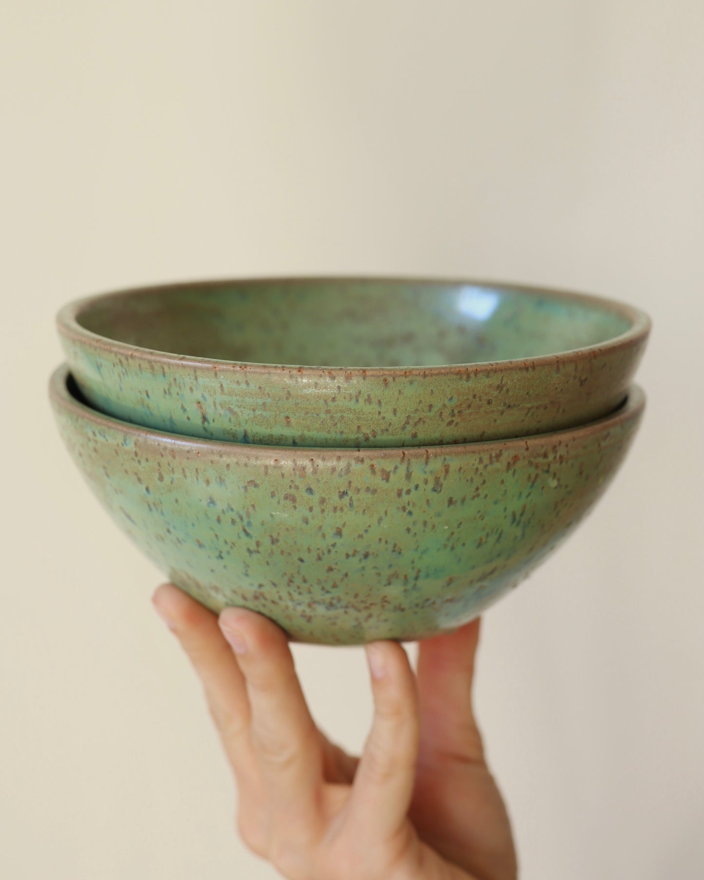 handmade ceramic speckled stoneware bowl set in green tea glaze