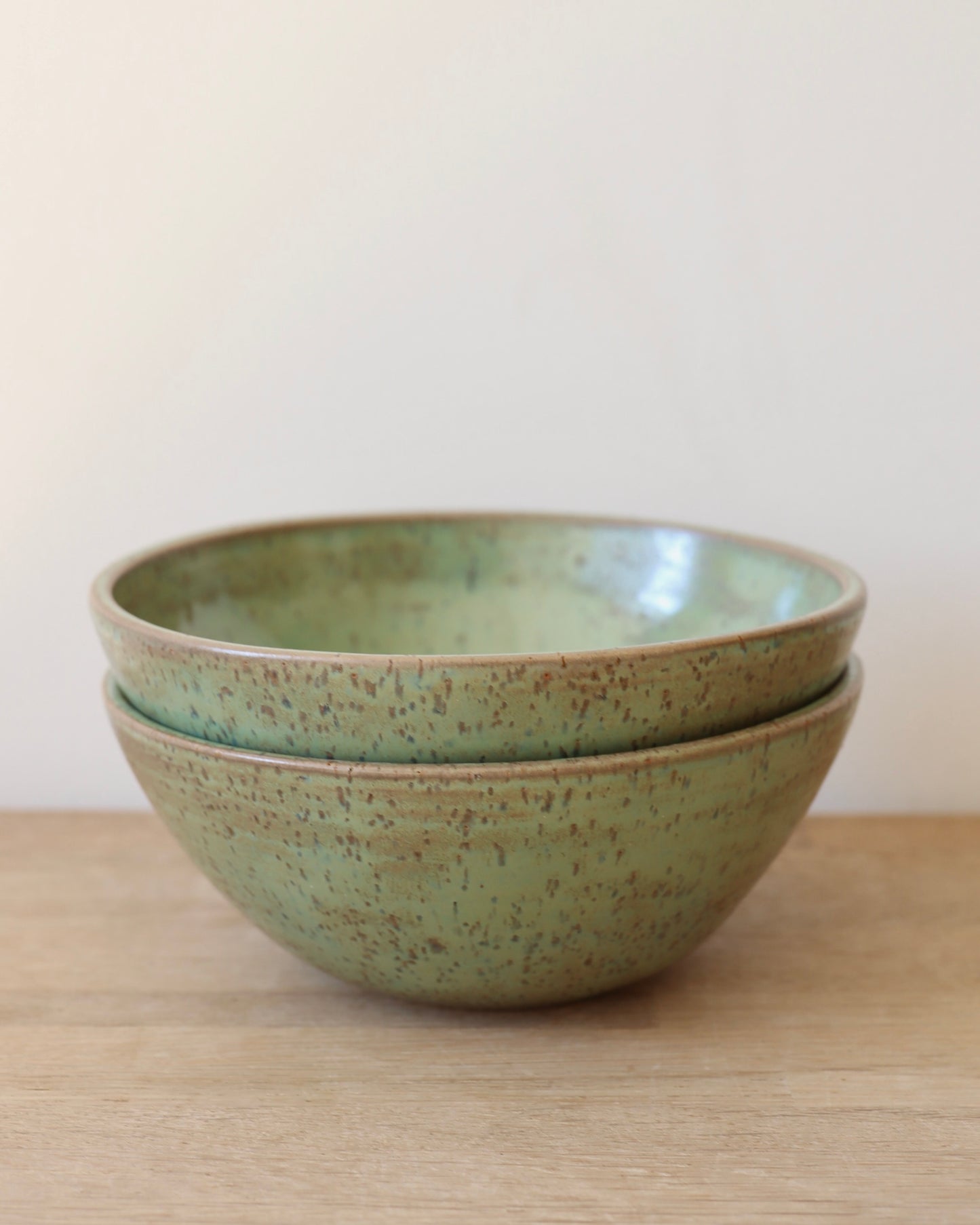 handmade ceramic speckled stoneware bowl set in green tea glaze