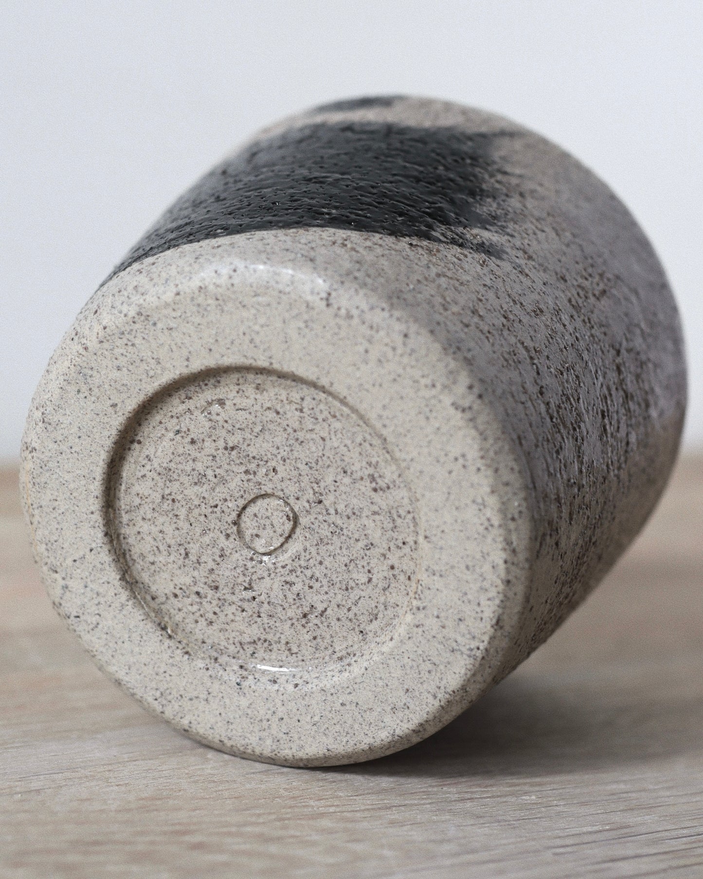 Grey Brush-Stroked Cup – handmade grey speckled stoneware cup with black brushstrokes and clear glaze, crafted in Amsterdam by Zeyah Ceramics.