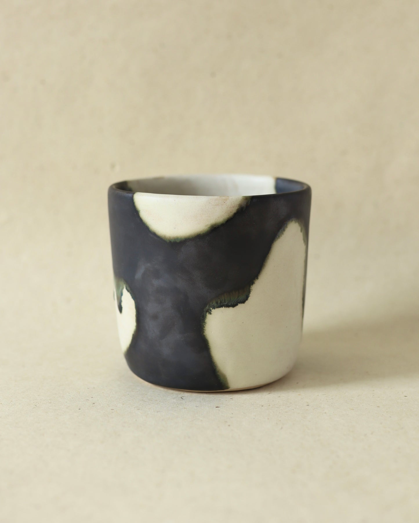 Handmade and wheelthrown ceramic white stoneware cup in a playful matte alabaster metallic glaze, perfect for coffee and tea