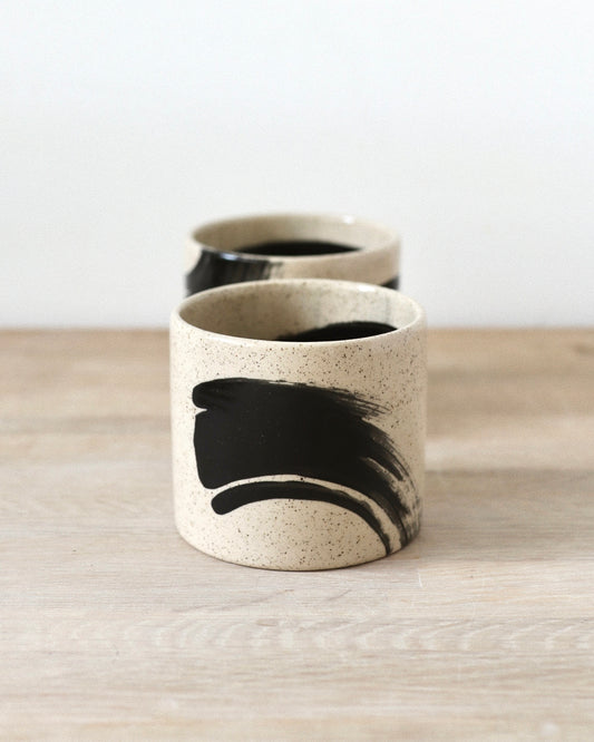 Speckled Brush-Stroked Set – handmade speckled white stoneware cup pair with expressive brush-strokes and clear glaze, crafted in Amsterdam by Zeyah Ceramics.