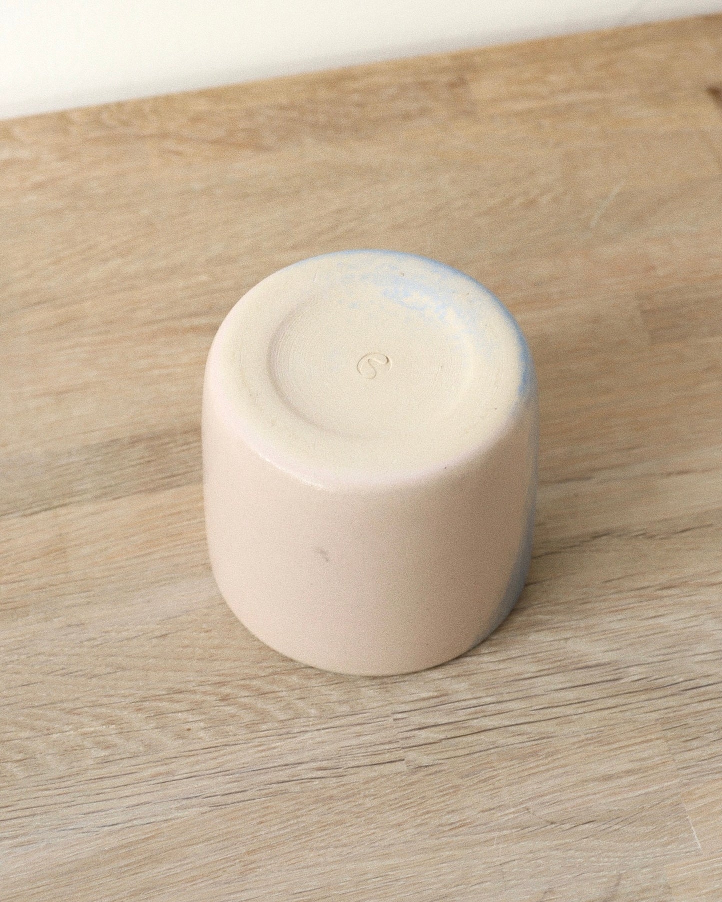 Cloud Cup – handmade white stoneware cup with soft pink and blue cloud-like underglazes and clear glaze, crafted in Amsterdam by Zeyah Ceramics.