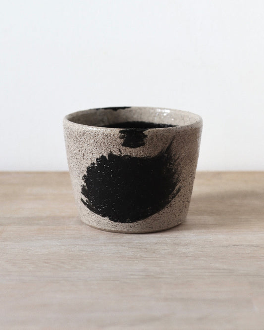 Grey Brush-Stroked Cup – handmade grey speckled stoneware cup with black brushstrokes and clear glaze, crafted in Amsterdam by Zeyah Ceramics.