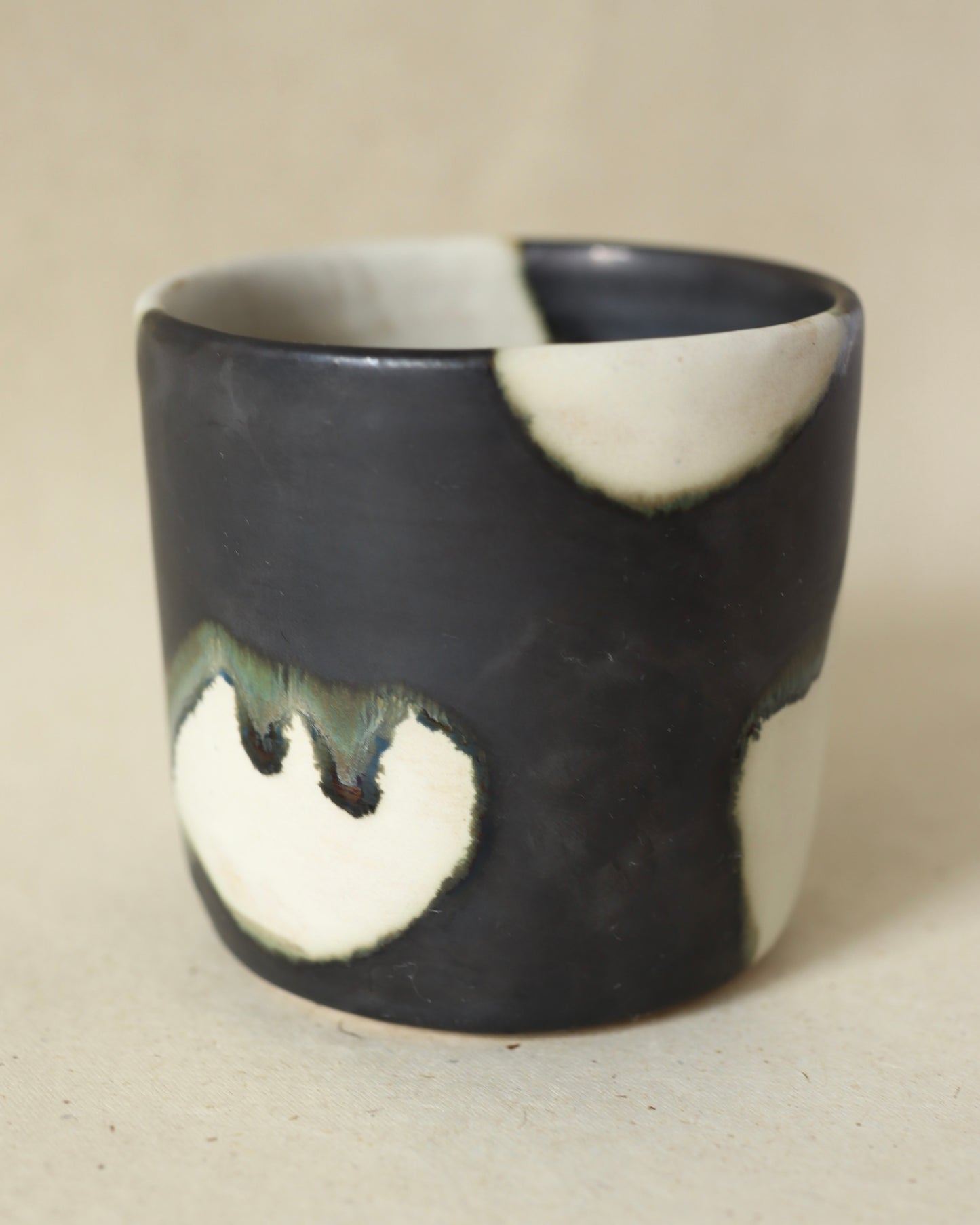 Handmade and wheelthrown ceramic white stoneware cup in a playful matte alabaster metallic glaze, perfect for coffee and tea