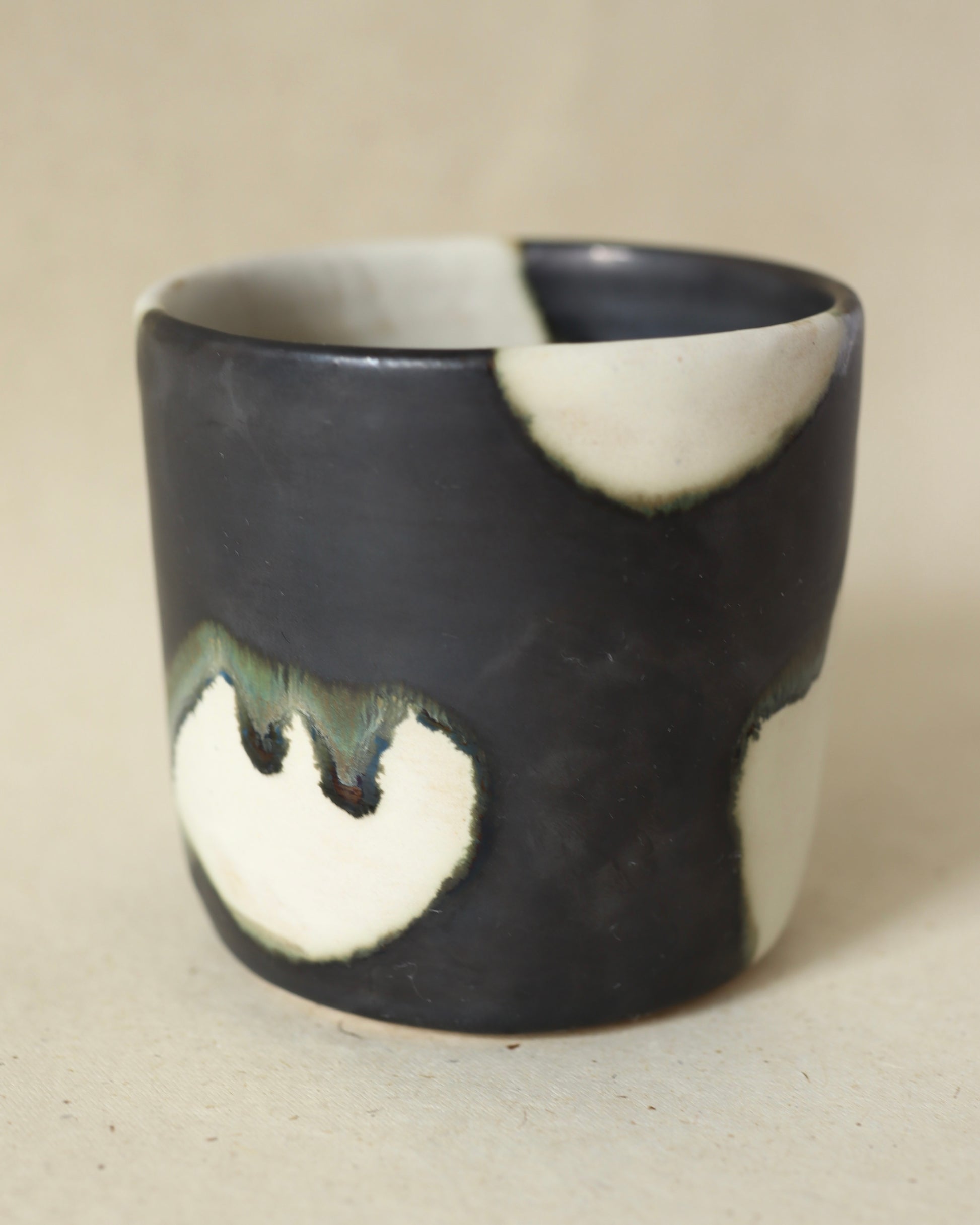Handmade and wheelthrown ceramic white stoneware cup in a playful matte alabaster metallic glaze, perfect for coffee and tea