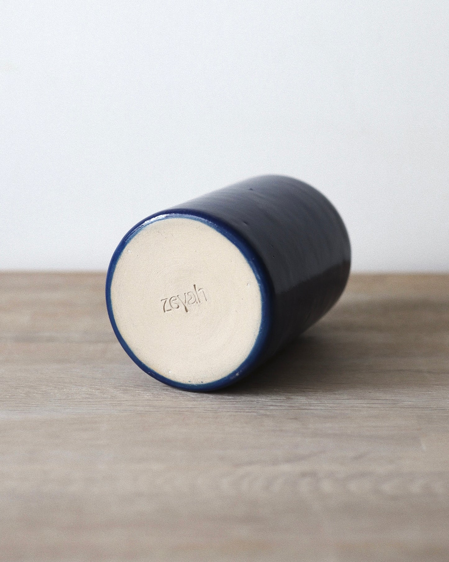 Nila Vase – handmade stoneware vase in deep blue glaze with a clean cylindrical form, crafted in Amsterdam by Zeyah Ceramics.