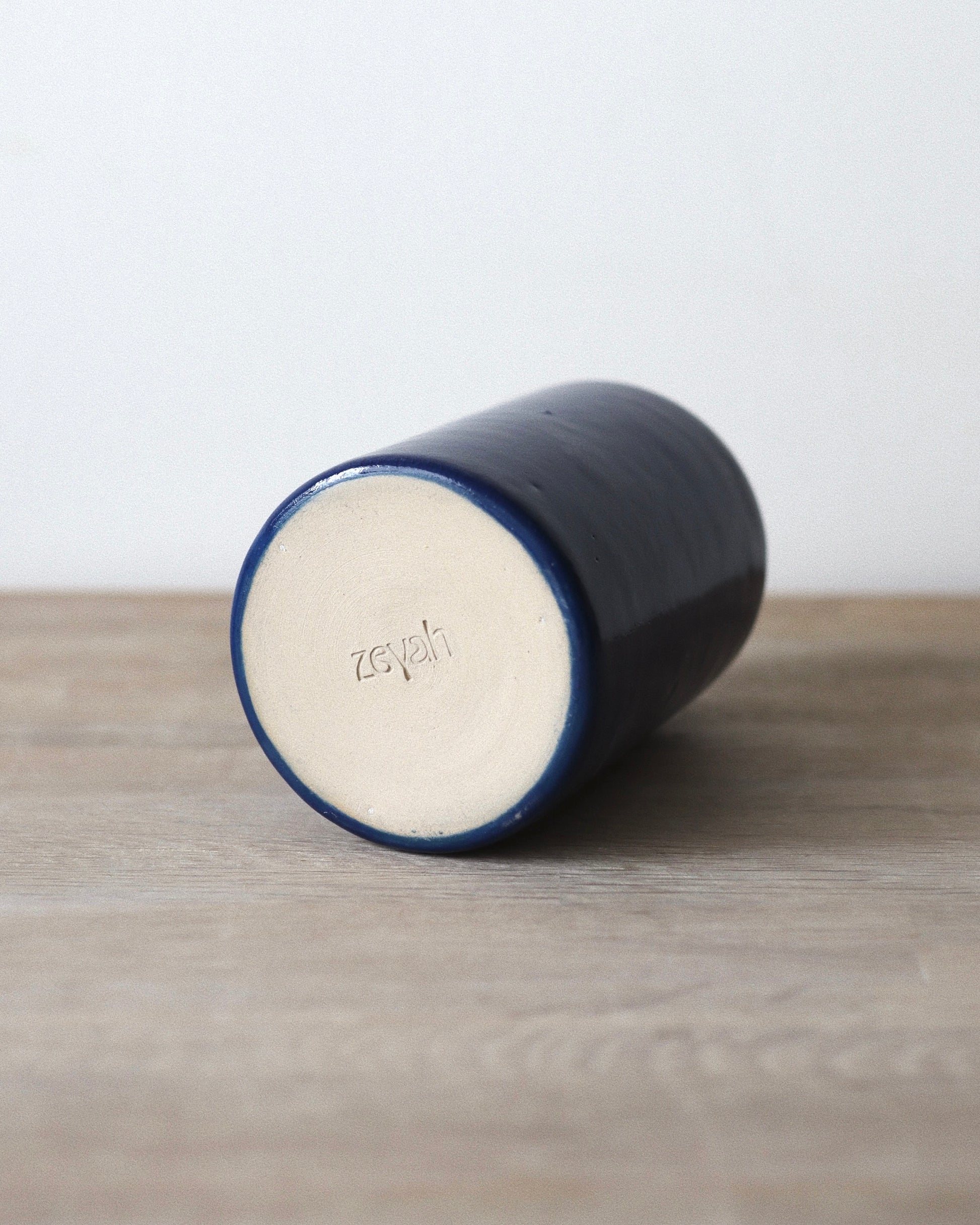 Nila Vase – handmade stoneware vase in deep blue glaze with a clean cylindrical form, crafted in Amsterdam by Zeyah Ceramics.