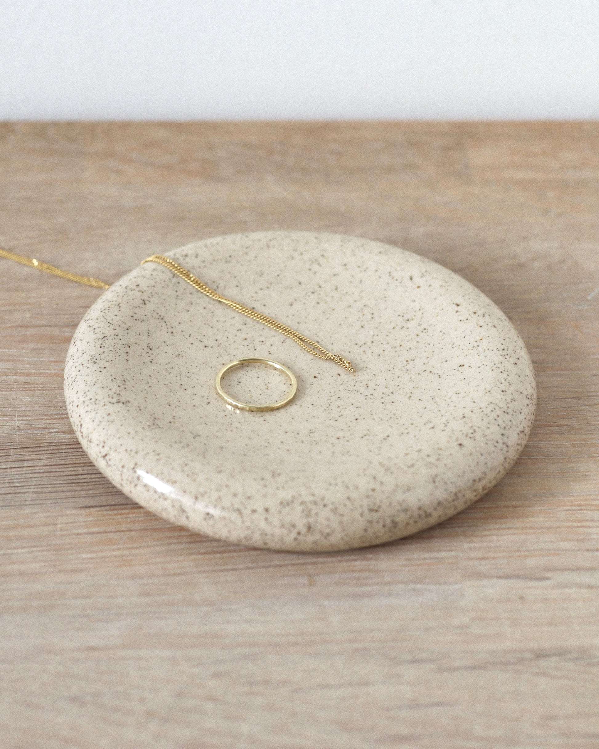 Sora Jewelry Dish – handmade white speckled stoneware jewelry dish with clear glaze, crafted in Amsterdam by Zeyah Ceramics.