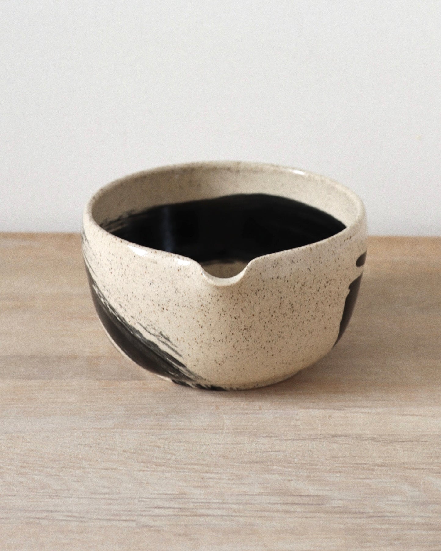 Brush-Stroked Matcha Set 2 – handmade white stoneware matcha bowl and whisk holder with black brushstrokes and clear glaze, crafted in Amsterdam by Zeyah Ceramics.