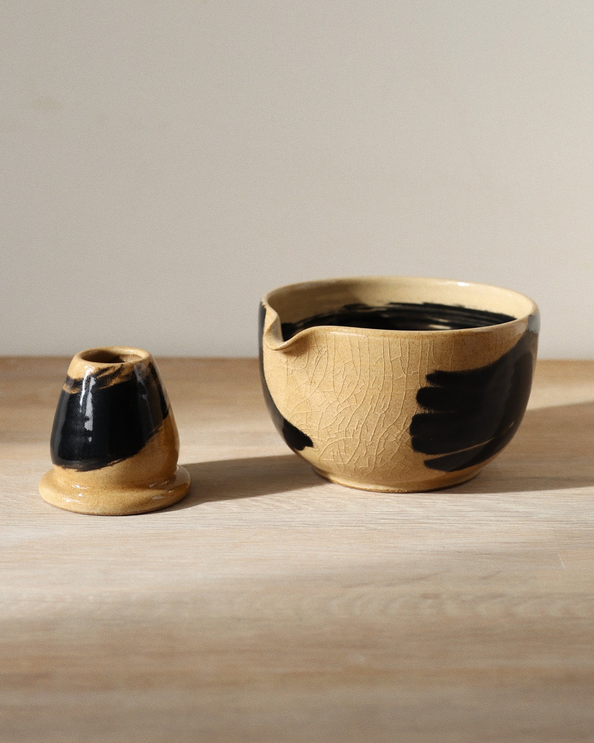 Brush-Stroked Matcha Set – handmade white stoneware bowl and whisk holder with expressive black brush-strokes and clear glaze, crafted in Amsterdam by Zeyah Ceramics.