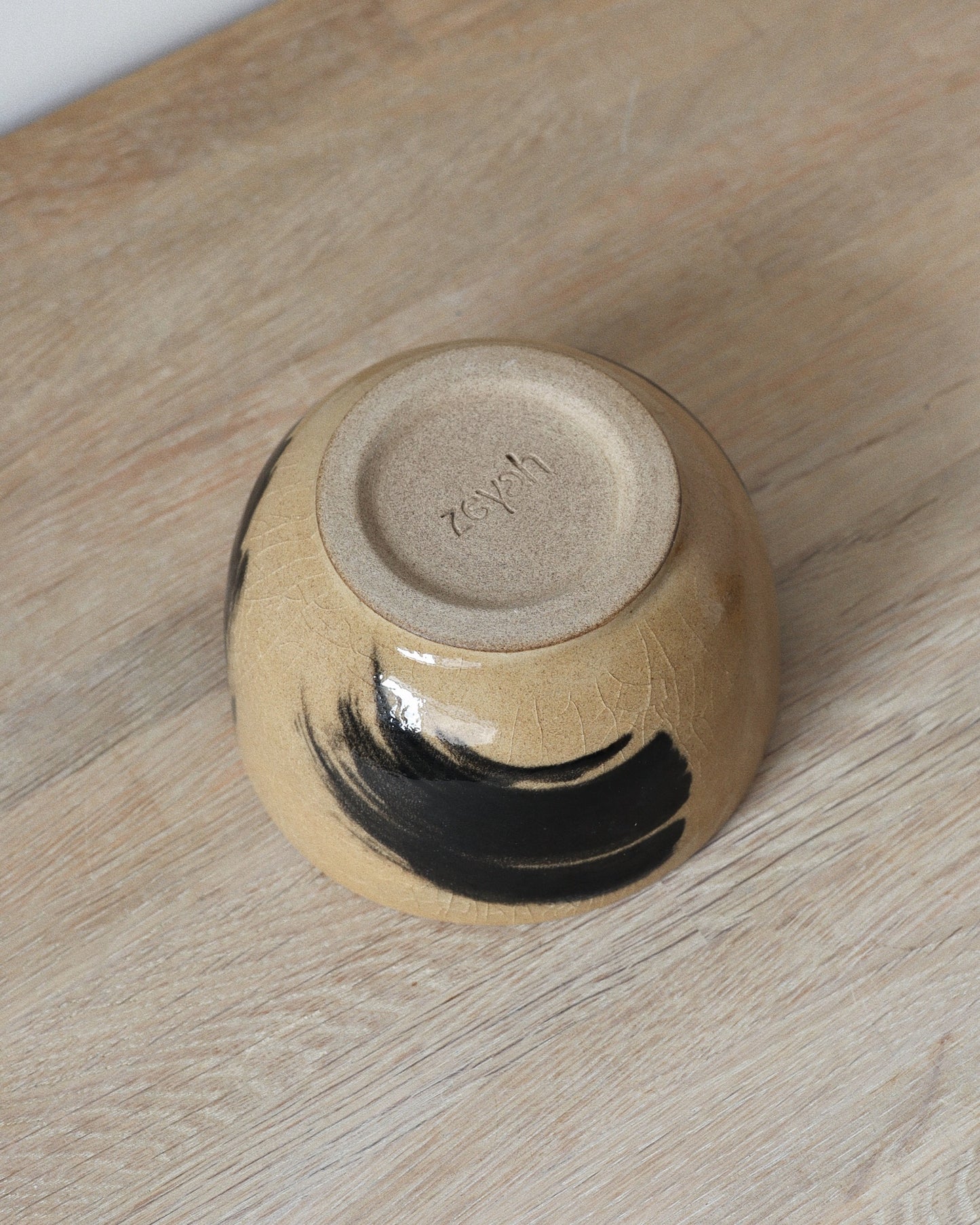 Brush-Stroked Matcha Set – handmade white stoneware bowl and whisk holder with expressive black brush-strokes and clear glaze, crafted in Amsterdam by Zeyah Ceramics.