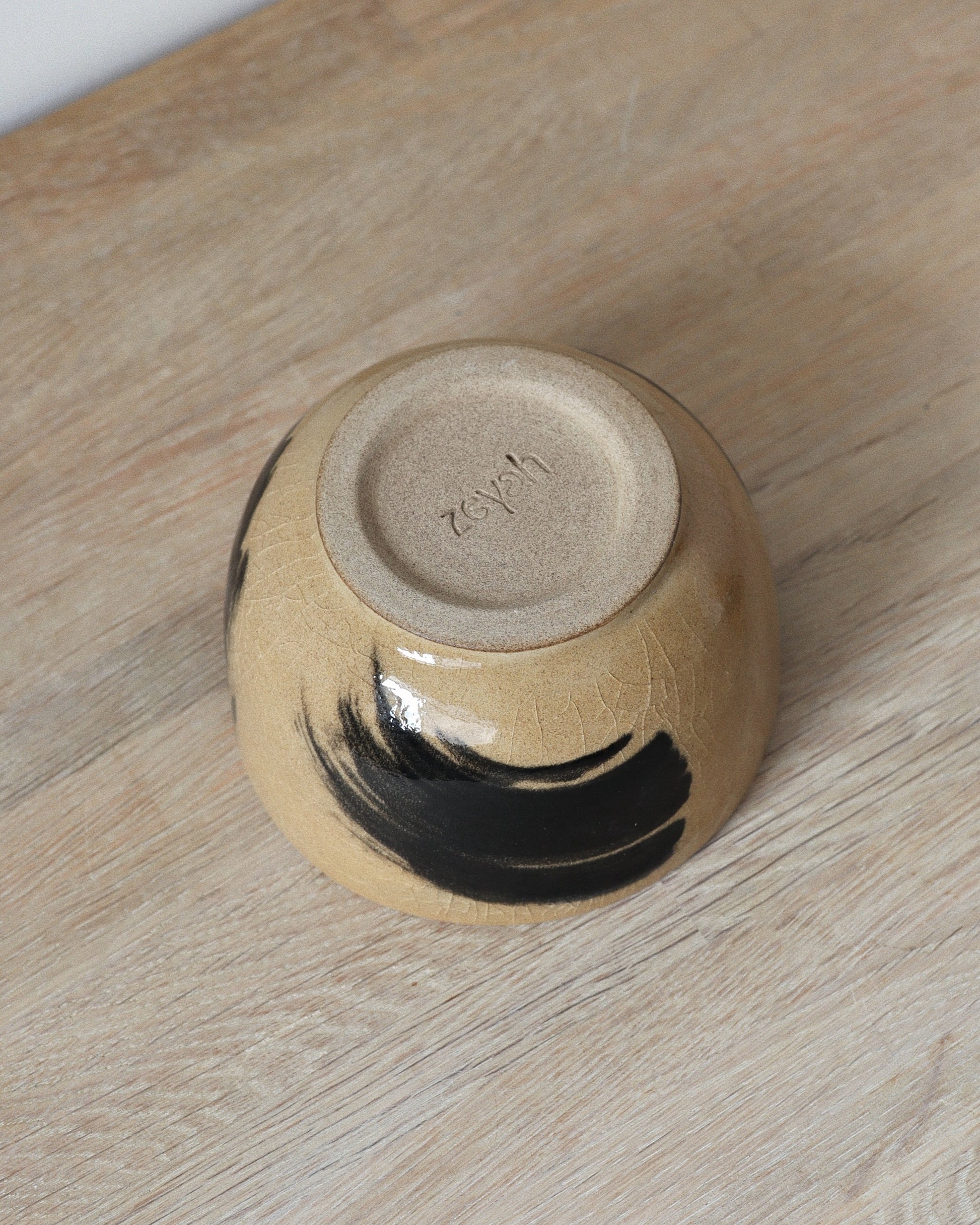 Brush-Stroked Matcha Set – handmade white stoneware bowl and whisk holder with expressive black brush-strokes and clear glaze, crafted in Amsterdam by Zeyah Ceramics.